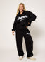 Black oversized hoodie with white embroidered DÈSVU logo at chest-4