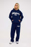 Navy blue leopard hoodie and joggers with 'DÈS VU' logo on a white background