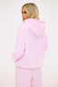 Person wearing a pink hoodie on a white background