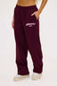 Burgundy joggers with dés vu logo in pink on a white background
