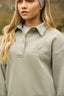 The image shows the Dès Vu Farmhouse Collection Polo Jumper in colour Olive