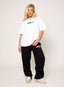 Model wearing oversized white 422 DÈSVU logo t-shirt with black embroidery-4
