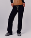 A model wearing navy sweatpants with yellow drawstrings, shown from the waist down against a light gray studio background.