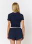 Woman wearing navy waffle baby tee and shorts on a white background.