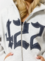 Closeup of woman wearing grey hoodie with navy '422' branding.