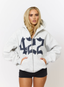 Woman wearing grey hoodie with navy '422' branding on a white background.