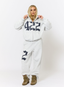 Woman wearing grey tracksuit with navy '422' branding on a white background.