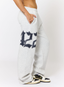 Woman wearing grey joggers with navy '422' branding on a white background.