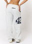 Woman wearing grey joggers with navy '422' branding on a white background.