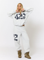 Woman wearing grey tracksuit with navy '422' branding on a white background.