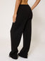 Woman wearing black waffle joggers on a white background.