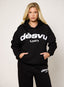 Black oversized hoodie with white embroidered DÈSVU logo at chest-2