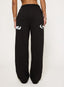 Black joggers with DÈS VU logo  on a plain background