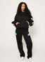 Black tracksuit with DÈS VU logos  on a plain background
