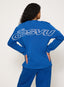 Person wearing a blue outfit with 'desvu' branding on a white background