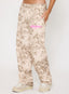 Camouflage pants with pink text on a white background