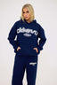 Navy blue hoodie and joggers with 'DÈS VU' logo on a white background