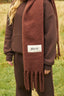 The image shows the Dès Vu Farmhouse Collection Knitted Scarf in colour Chocolate