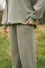 The image shows the Dès Vu Farmhouse Collection Polo Jumper and Wide Leg Joggers in colour Olive