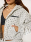 Person wearing a gray polka dot hoodie with 'desvu' branding.