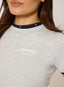 Close-up of a person wearing a gray t-shirt with 'desvu' branding.