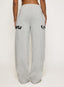 Grey joggers with DÈS VU logo  on a plain background