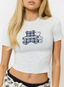 Woman wearing grey t-shirt with teddy plaid print 'des vu' branding on a white background.