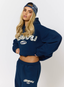 Woman wearing navy hoodie with leopard print pattern 'des vu' branding on a white background.