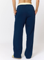 Woman wearing navy leopard print joggers on a white background.