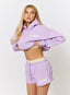 Woman wearing lilac hoodie and shorts with '422' branding on a white background.