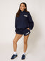 Woman wearing navy hoodie and shorts with '422' branding on a white background.