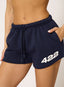 Woman wearing navy shorts with '422' branding on a white background.
