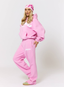 Woman wearing pink tracksuit with 'des vu' branding on a white background.