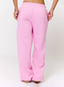 Woman wearing pink joggers on a white background.
