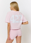 Woman wearing pink striped t shirt with '422' branding on a white background.