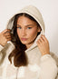 Woman wearing stone hoodie with '422' branding on a white background.