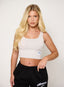 Woman wearing a stone tank top and black joggers