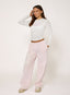 Woman wearing white sheer long sleeve t-shirt with '422' branding on a white background.